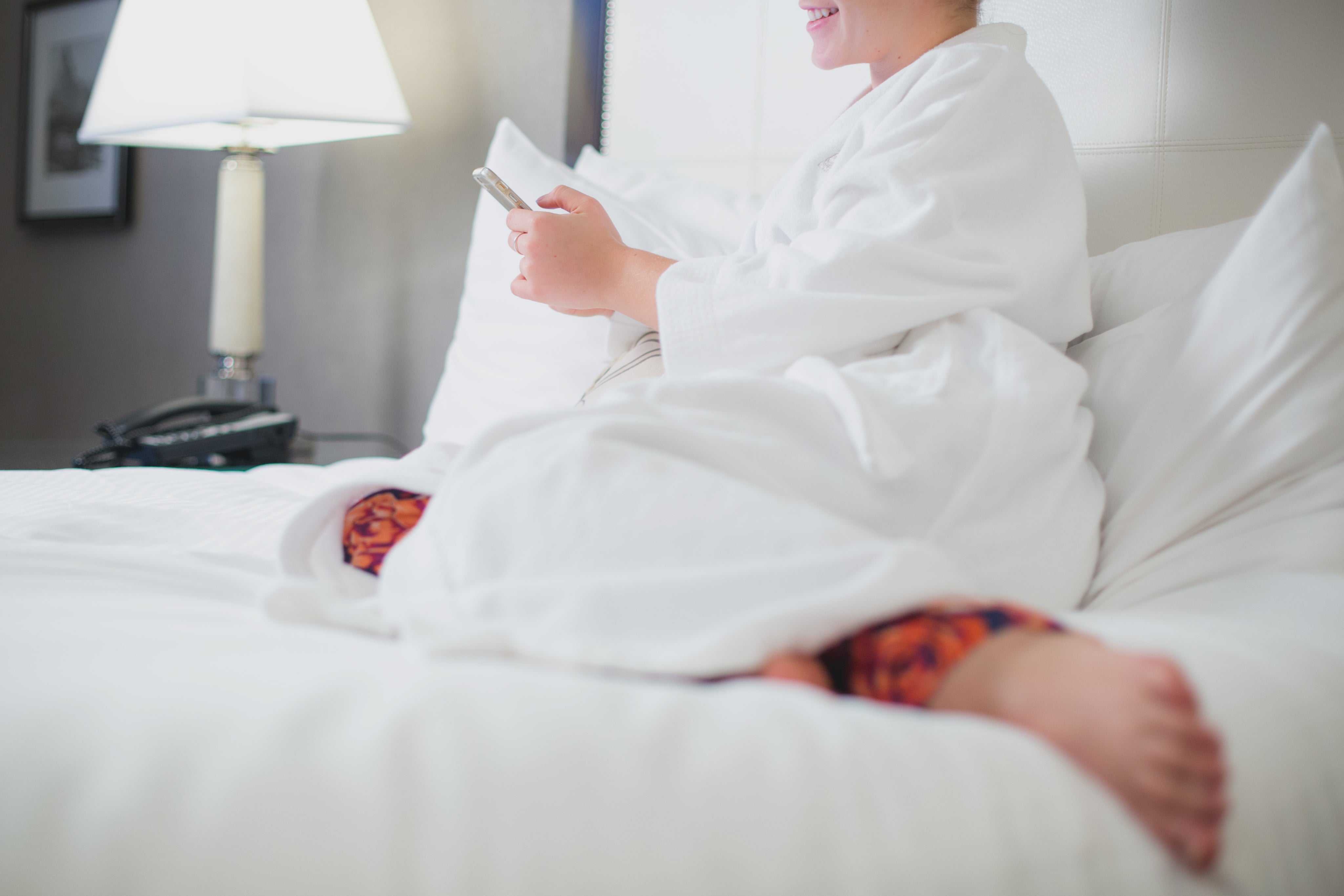 Femme relax sur un lit blanc confortable